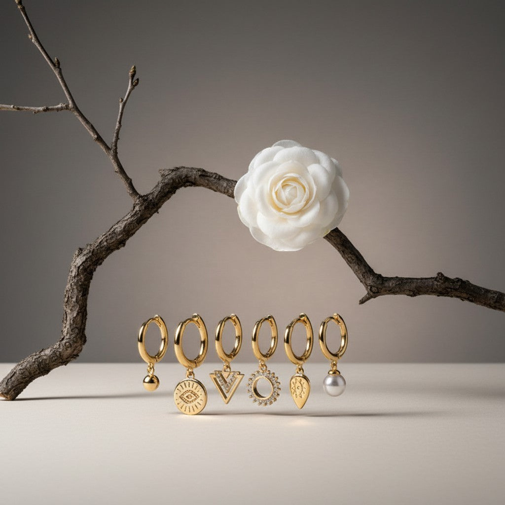 Aramat Jewels set of 6 gold-plated 925 silver hoop earrings with charms: pearl, evil eye, triangle, sunburst, and teardrop.