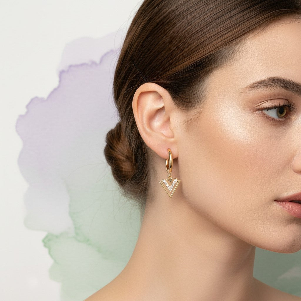 Aramat Jewels set of 6 gold-plated hoop earrings with charms: pearl, evil eye, triangle, sunburst, and teardrop.