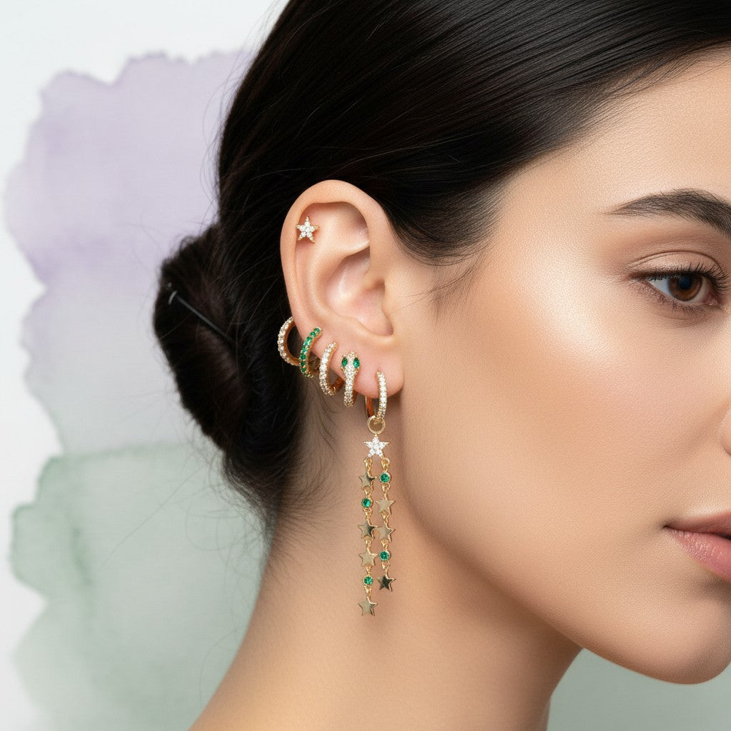 Aramat Jewels set of 5 gold-plated 925 silver earrings with stars, green stones, snake, and chain designs.