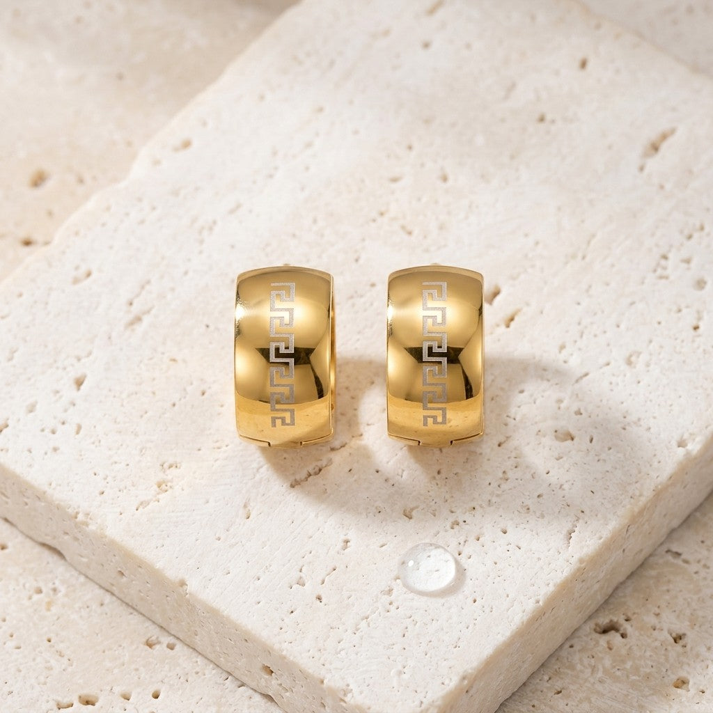 Aramat Jewels gold-tone stainless steel hoop earrings with Greek key pattern, 13mm diameter.