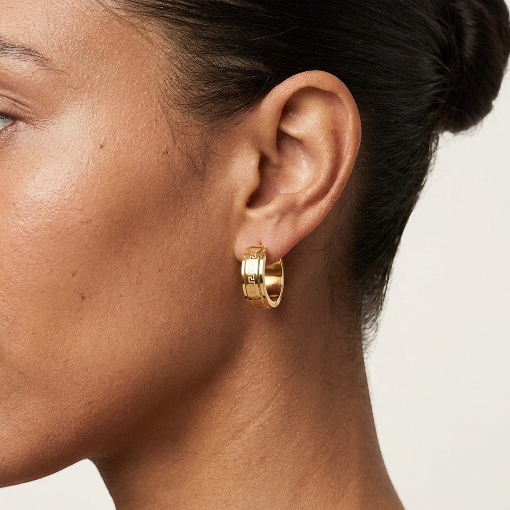 Aramat Jewels gold-tone stainless steel hoop earrings with Greek key pattern, 13mm or 20mm diameter.