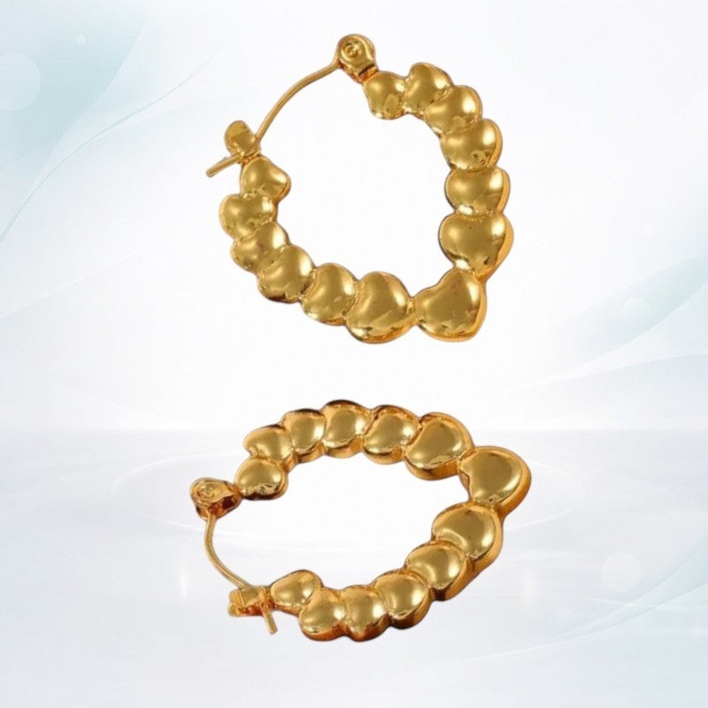 Aramat Jewels gold-tone stainless steel hoop earrings with a heart motif, featuring a drop shape and hinge closure.