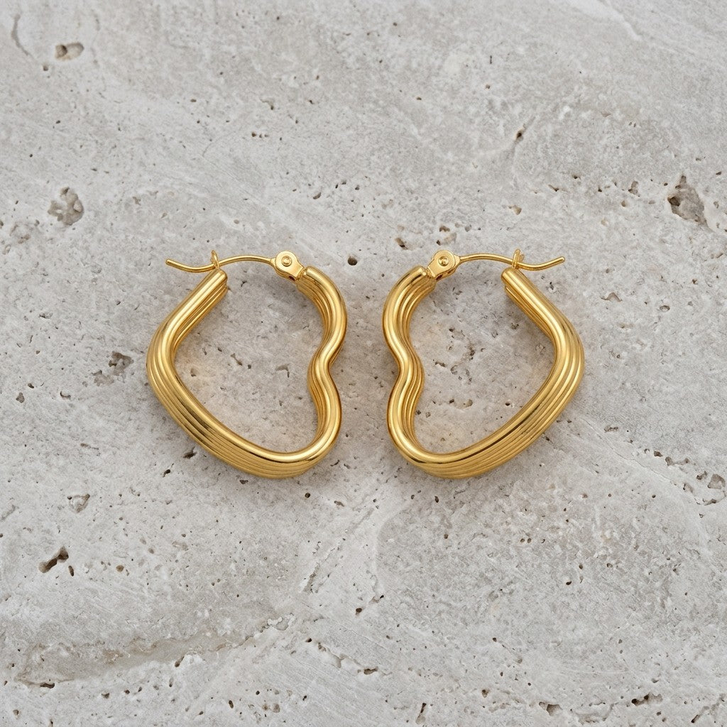 Aramat Jewels gold-tone stainless steel heart-shaped hoop earrings with triple ribbed detail.