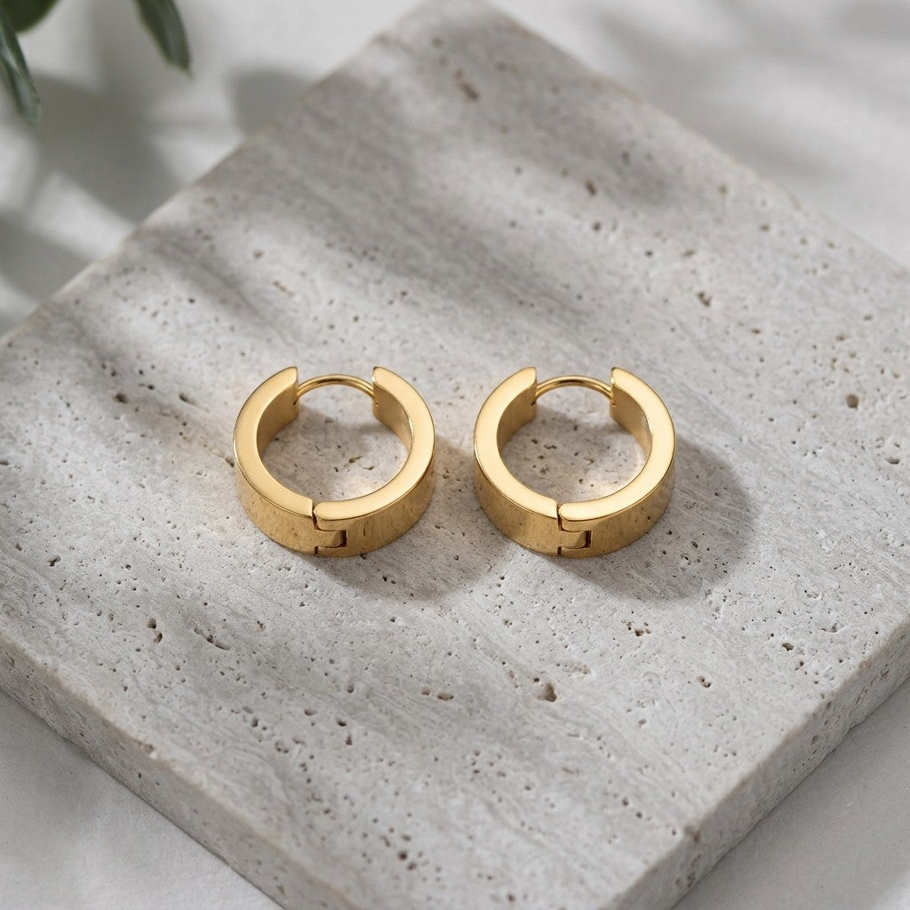Aramat Jewels gold-coloured stainless steel hoop earrings, 20mm diameter, smooth polished finish, classic design.