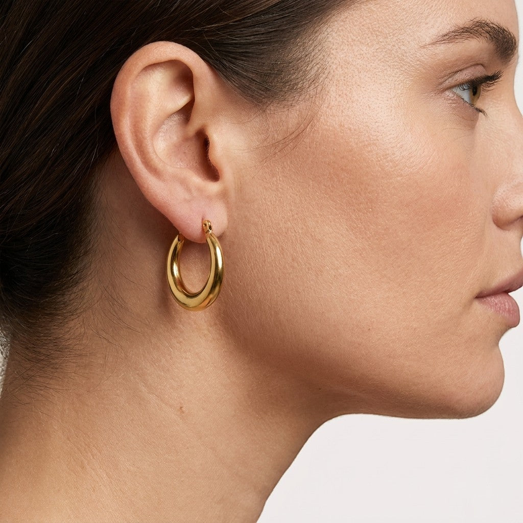 Aramat Jewels gold-tone stainless steel hoop earrings, 20mm diameter and 4mm wide, with a smooth, polished finish.