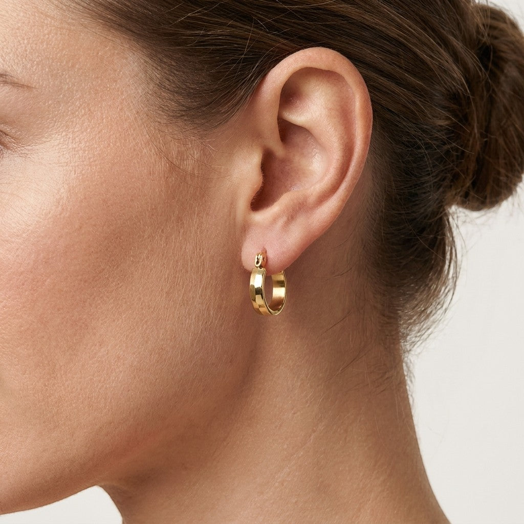 Aramat Jewels gold-tone stainless steel hoop earrings with a subtle block pattern, 10mm diameter.