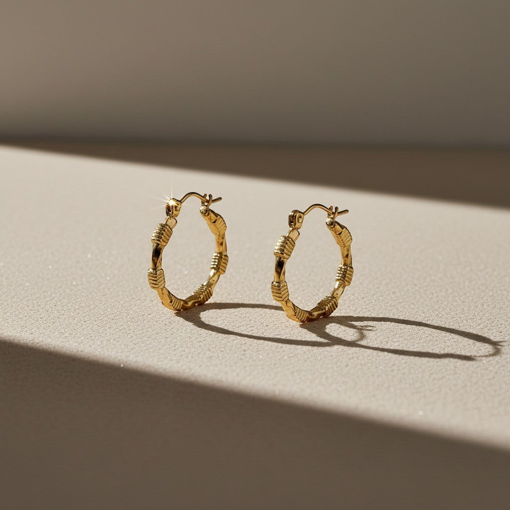 Aramat Jewels gold-coloured stainless steel hoop earrings with a block pattern and hinge closure, 25x23mm.
