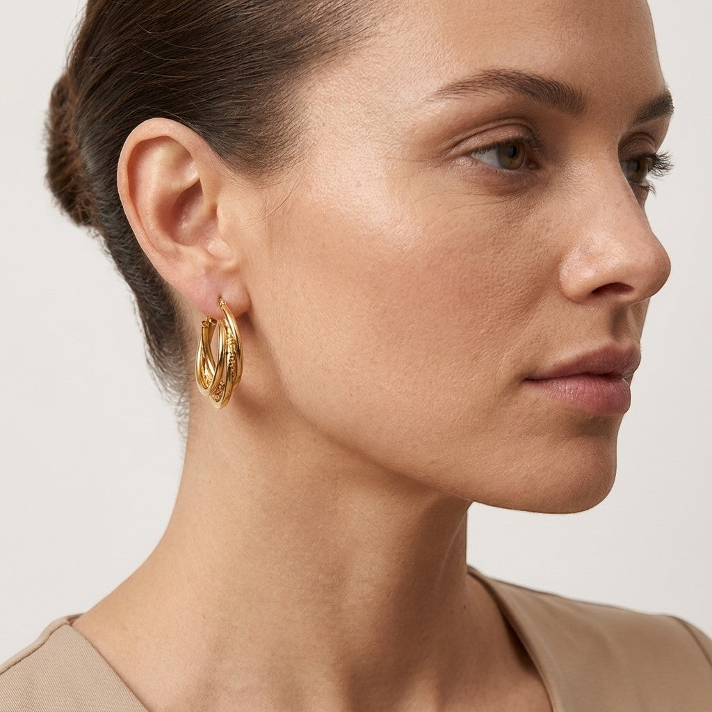 Aramat Jewels gold-tone 3-layer hoop earrings with braided detail, 25mm diameter, made of stainless steel.