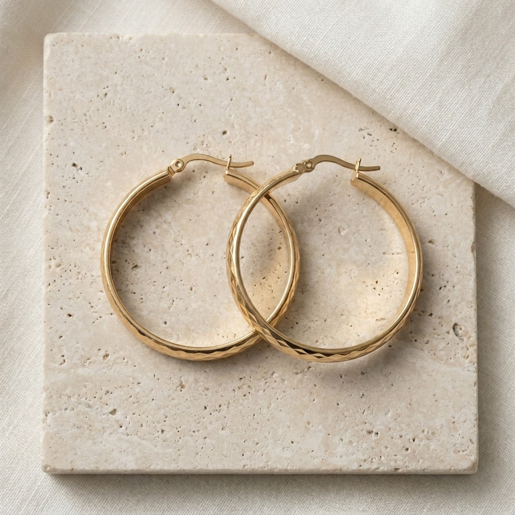 Aramat Jewels gold-tone stainless steel hoop earrings with a checkered pattern, 35mm diameter.