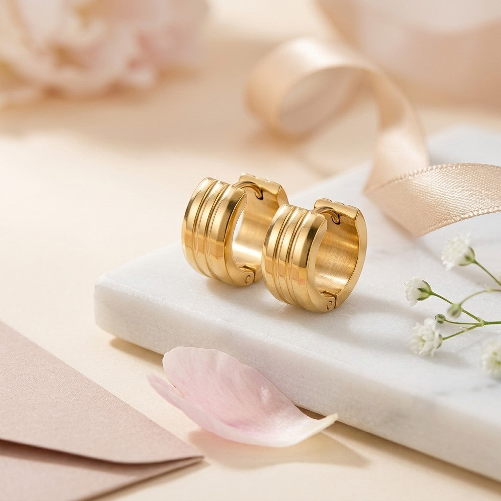 Aramat Jewels gold-tone stainless steel hoop earrings with double stripe detail, 13mm or 20mm diameter.