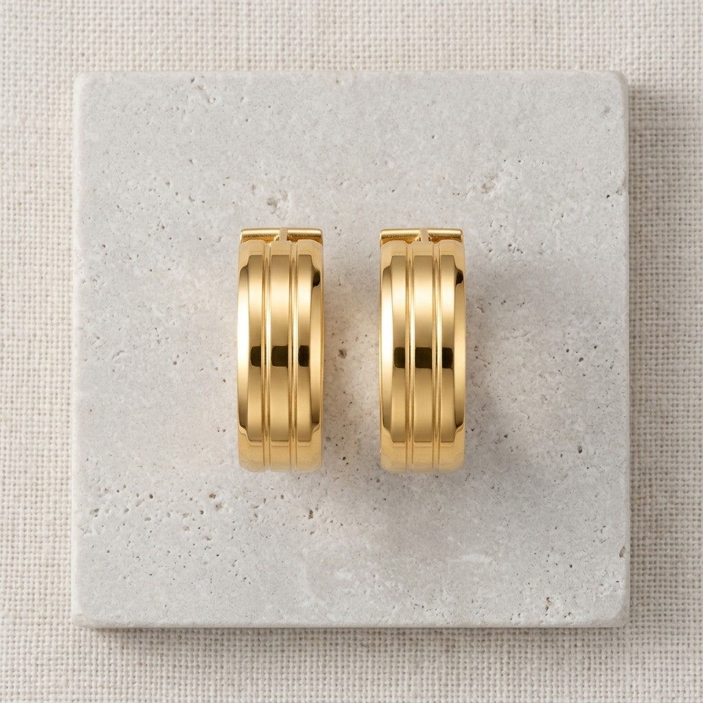 Aramat Jewels gold-tone stainless steel hoop earrings with double stripe detail, 13mm or 20mm diameter.