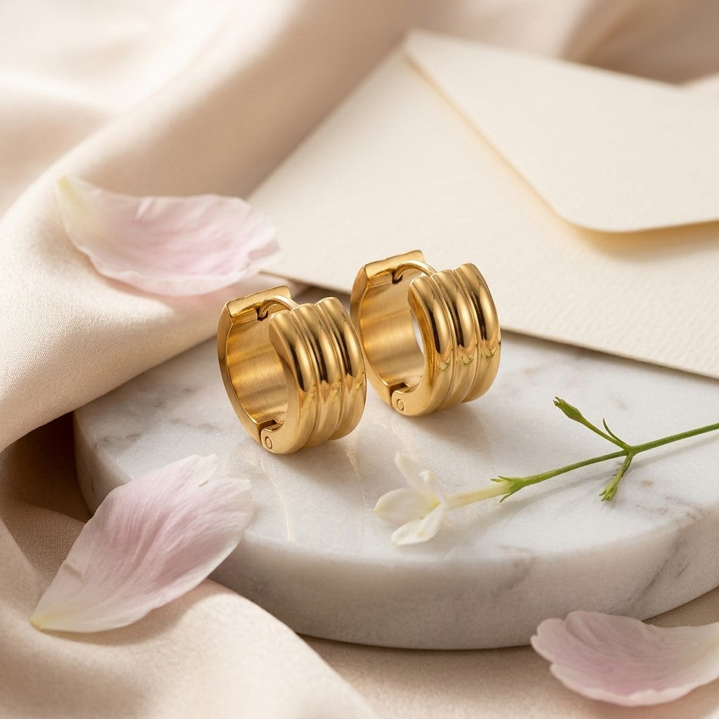 Aramat Jewels gold-tone stainless steel hoop earrings with ribbed detail, 13mm or 20mm diameter.