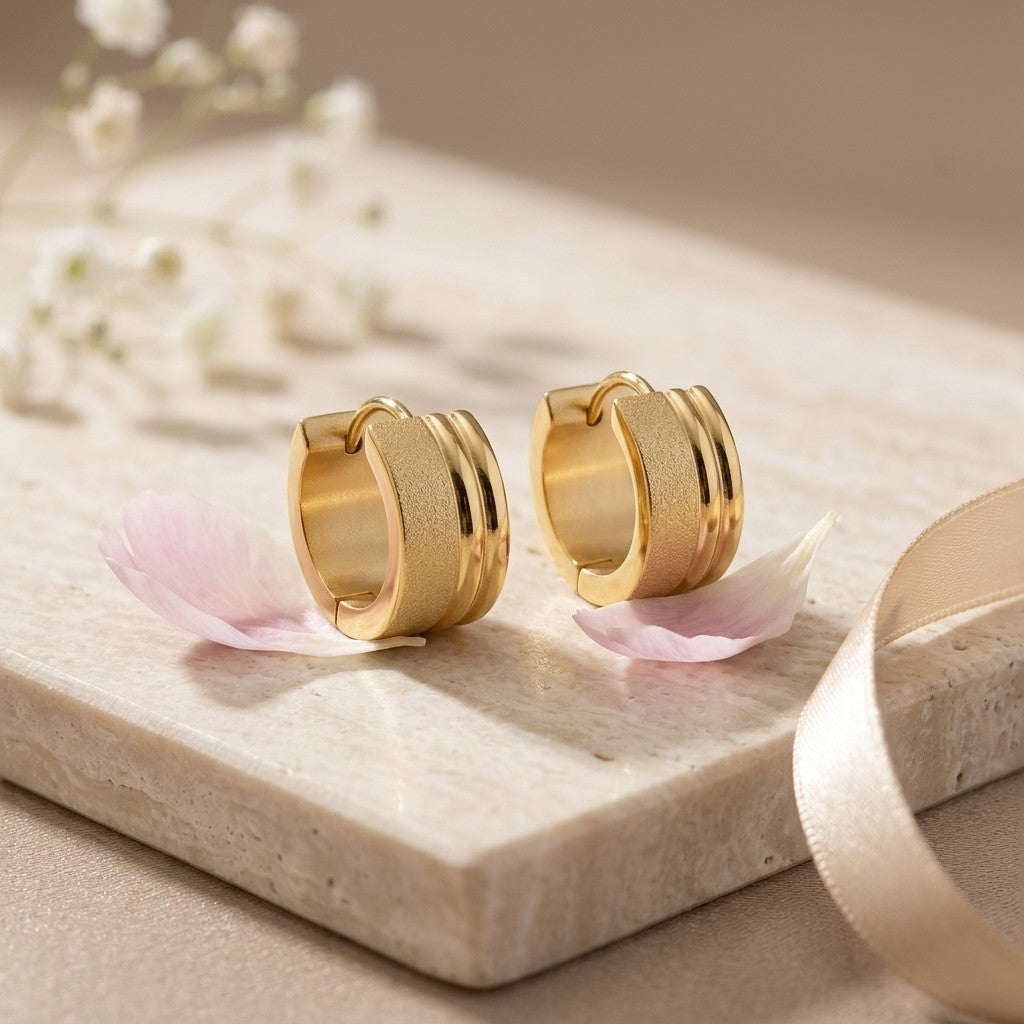 Aramat Jewels gold-tone stainless steel huggie hoop earrings with sandblasted and shiny stripes, 13x7mm.