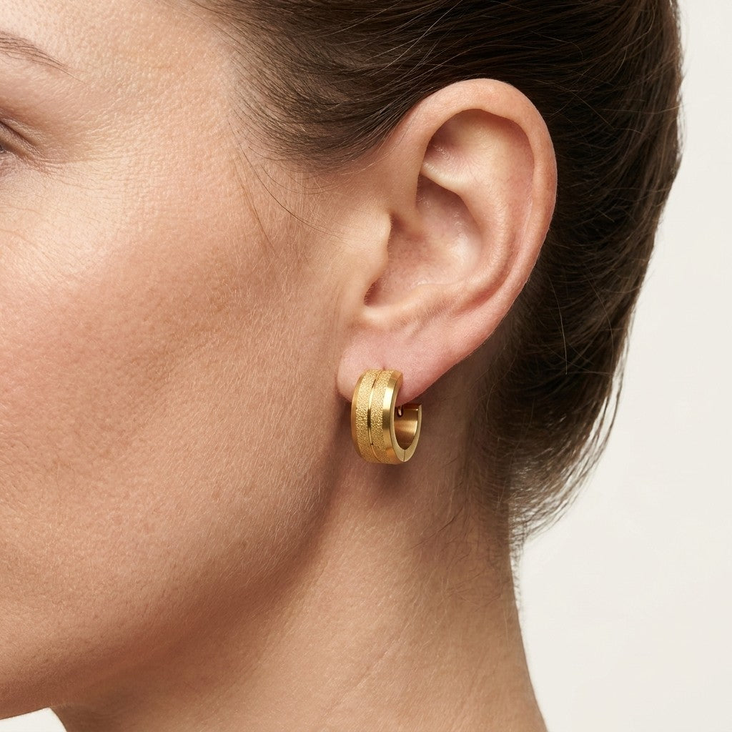 Aramat Jewels gold-coloured steel hoop earrings with sandblasted stripes, 13x7mm, for women.
