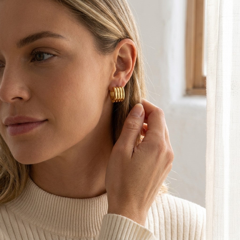 Aramat Jewels gold-tone stainless steel hoop earrings with triple stripe detail, 13mm or 20mm diameter.