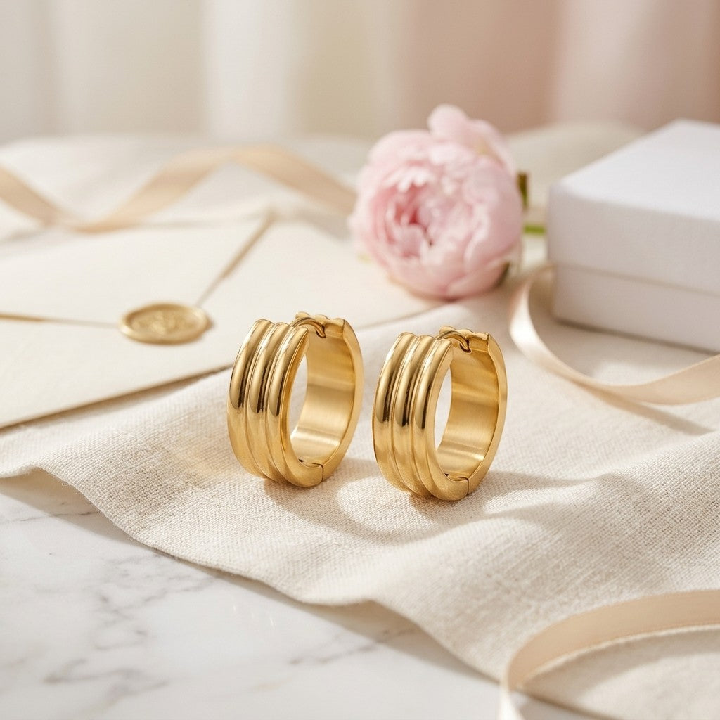 Aramat Jewels gold stainless steel hoop earrings with double stripe detail, available in 13mm or 20mm.