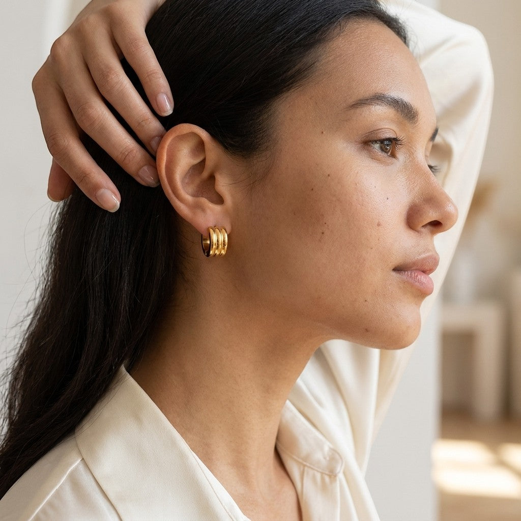 Aramat Jewels gold-tone stainless steel hoop earrings with two stripes, 13mm or 20mm diameter.