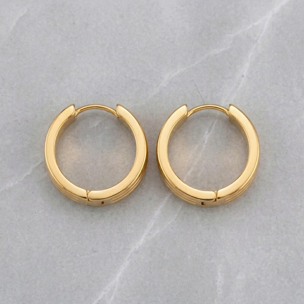 Aramat Jewels gold-tone stainless steel huggie hoop earrings with triple stripe detail, 13mm or 20mm diameter.