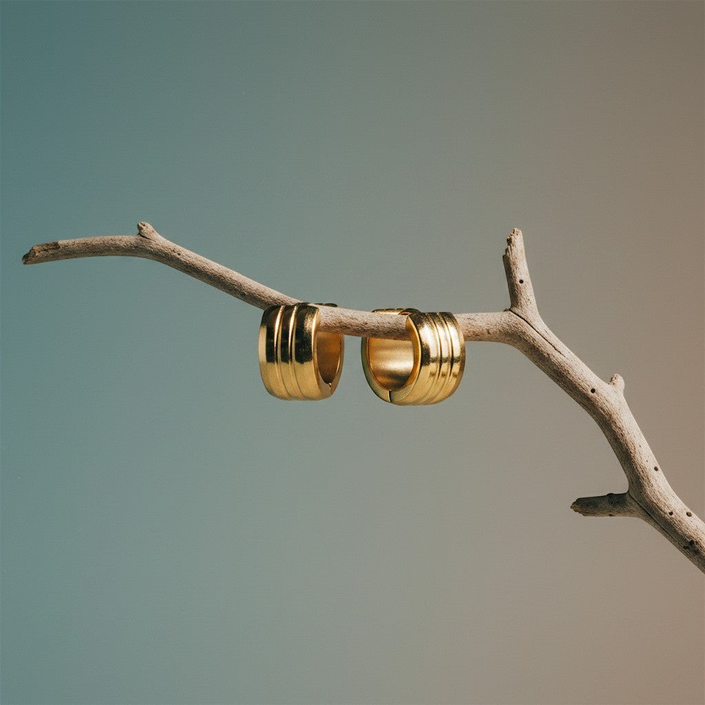 Aramat Jewels gold-tone stainless steel hoop earrings with two raised stripes, 13mm diameter.