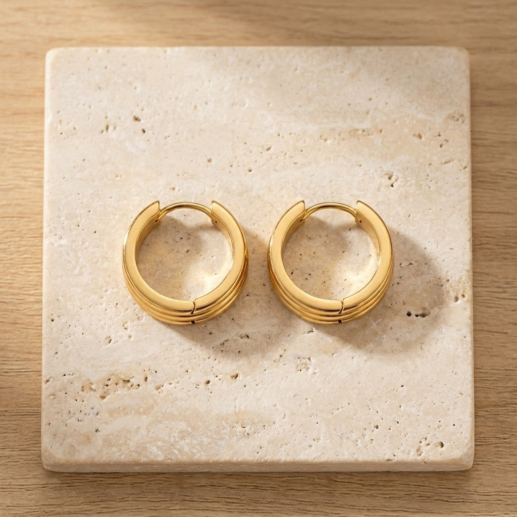 Aramat Jewels gold-tone stainless steel hoop earrings with double stripe detail, available in 13mm or 20mm.