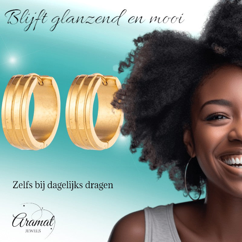 Aramat Jewels gold-tone stainless steel hoop earrings with two raised stripes, worn by a smiling woman.