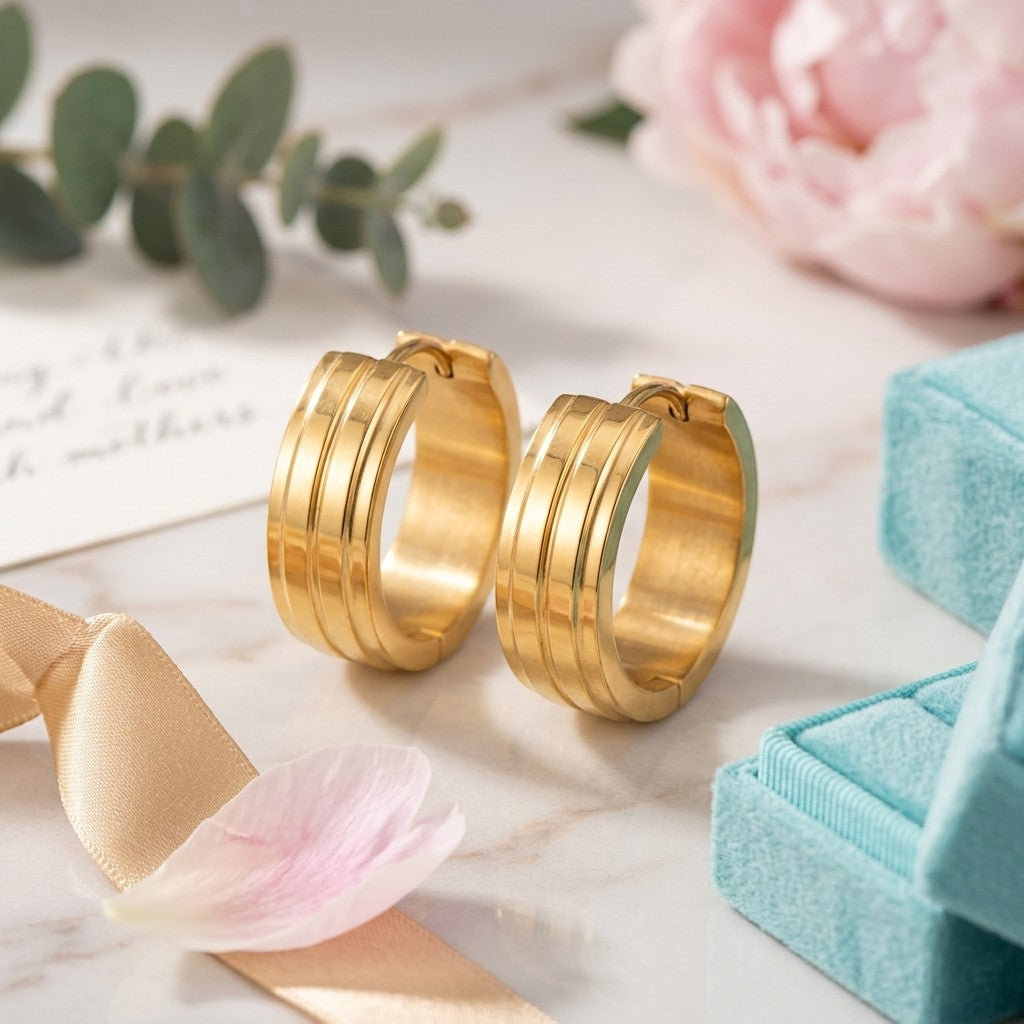 Aramat Jewels gold-tone stainless steel hoop earrings with two raised stripes, 20mm diameter.
