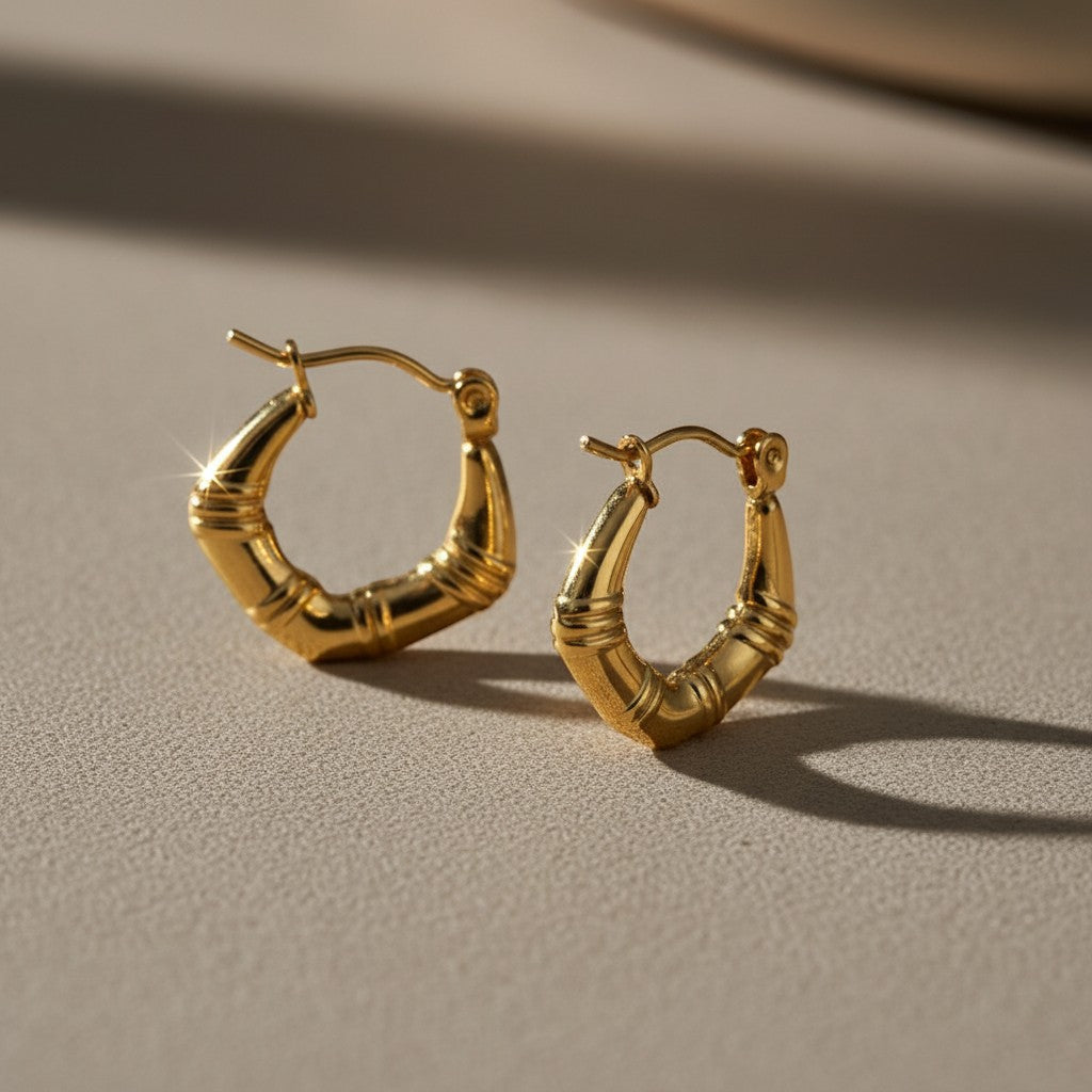 Aramat Jewels small gold-colored hoop earrings with a subtle striped texture, 20mm diameter, made of stainless steel.