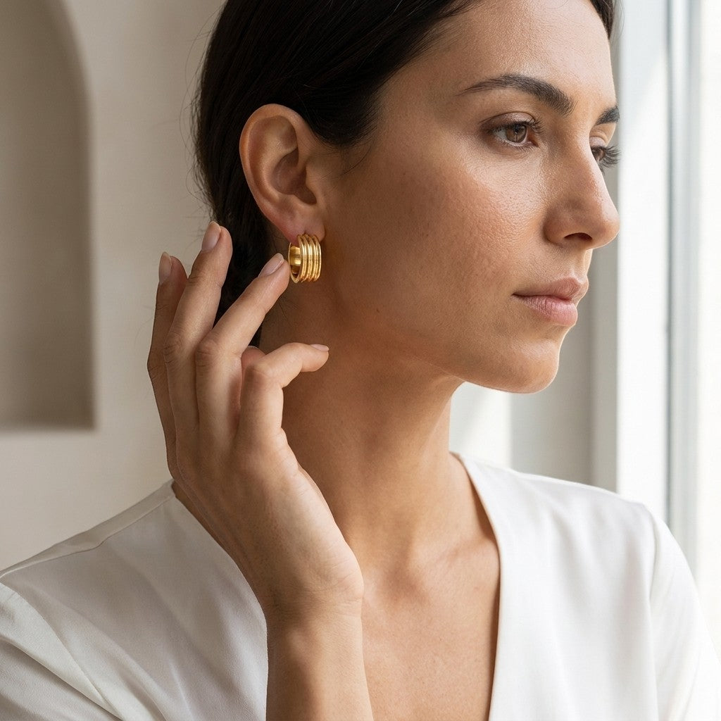 Aramat Jewels gold-tone stainless steel hoop earrings with triple stripe detail, 13mm or 20mm diameter.
