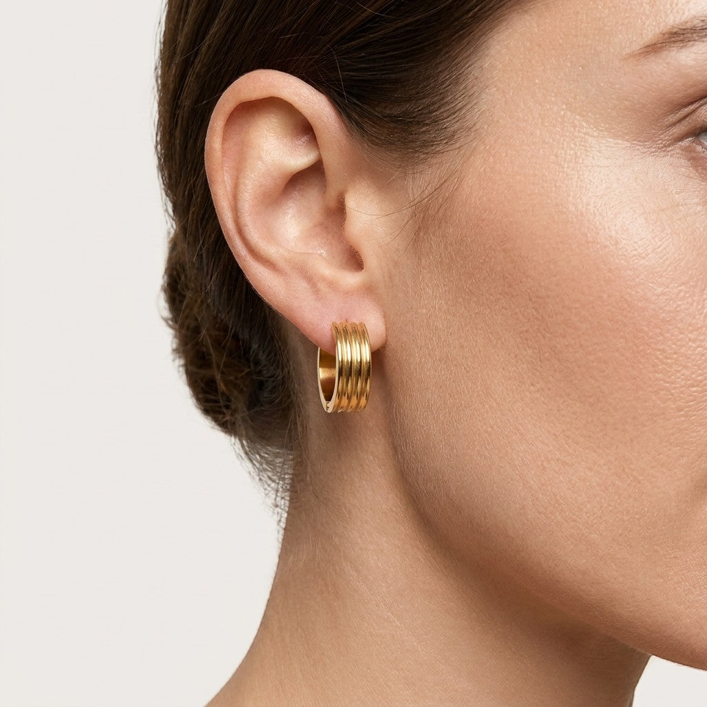 Aramat Jewels gold-tone stainless steel hoop earrings with triple stripe detail, 13mm or 20mm diameter.