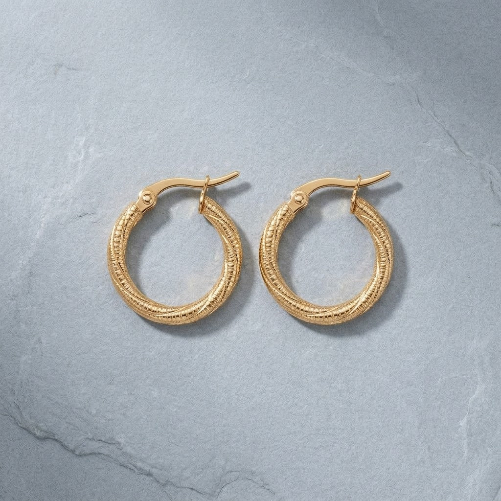 Aramat Jewels gold-tone twisted, diamond-cut stainless steel hoop earrings, 20mm diameter, with hinge clasp.
