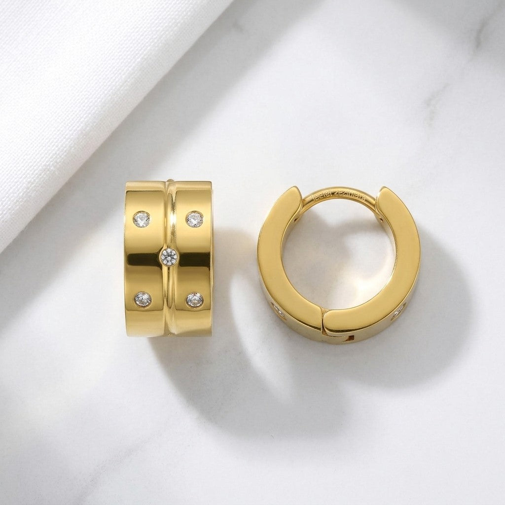 Aramat Jewels gold-tone stainless steel hoop earrings with 5 clear cubic zirconia stones.