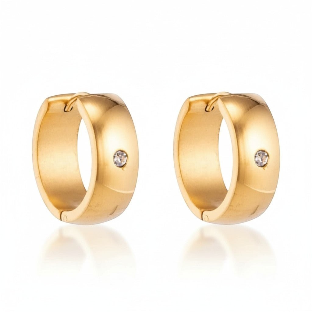 Aramat Jewels gold-tone stainless steel huggie hoop earrings with a central clear cubic zirconia stone.