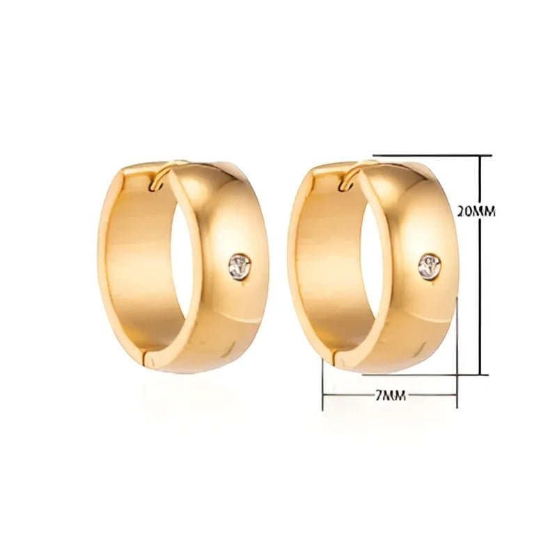 Aramat Jewels gold-tone stainless steel huggie hoop earrings with a central cubic zirconia stone. Dimensions shown are 20mm diameter and 7mm width.