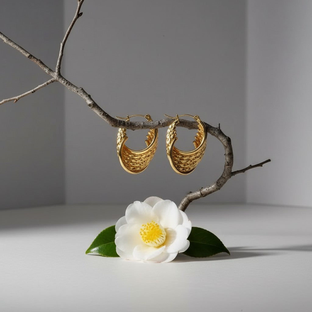 Aramat Jewels gold-tone stainless steel hoop earrings with a layered, twisted design. Each earring appears to have six hoops.