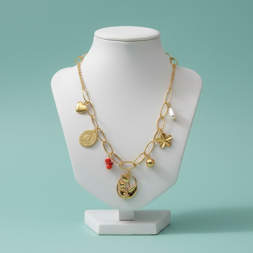 Aramat Jewels gold-tone stainless steel multi-charm necklace with pearl, red stone, heart, flower, and tulip charms.