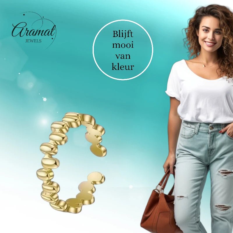 Aramat Jewels gold-colored adjustable stainless steel ring with an oval block pattern, worn as a stylish stackable ring.