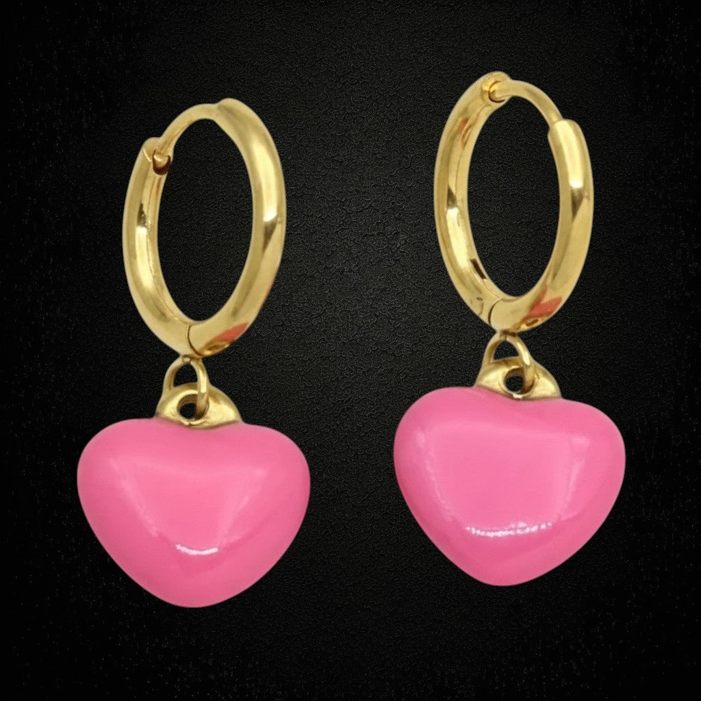 Aramat Jewels gold huggie hoop earrings with pink enamel heart charms. Stainless steel, 14mm hoop diameter, 12mm heart charm.