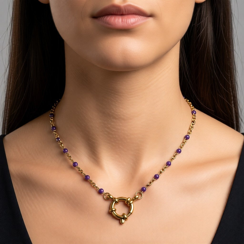 Aramat Jewels gold chain necklace with small purple enamel beads and a large circular clasp.