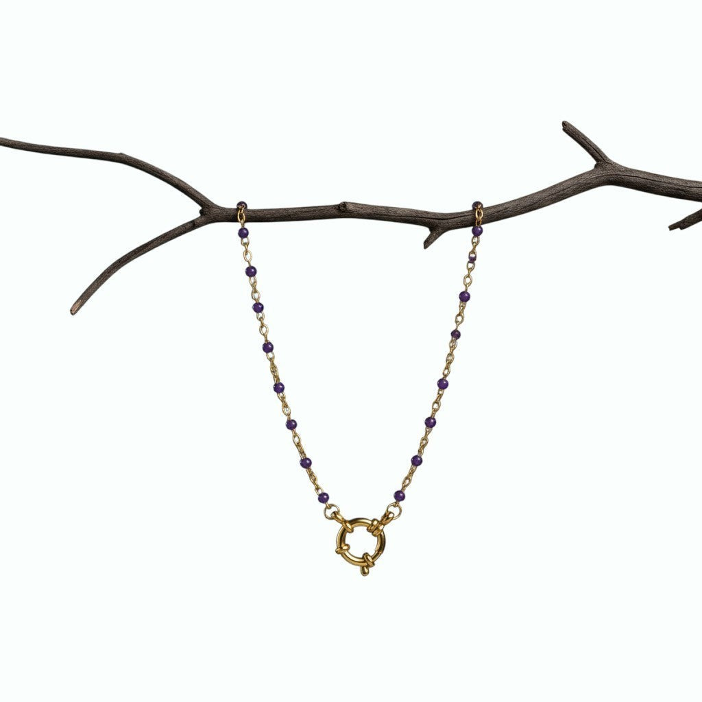 Aramat Jewels gold chain necklace with small purple enamel beads and a large circular clasp.