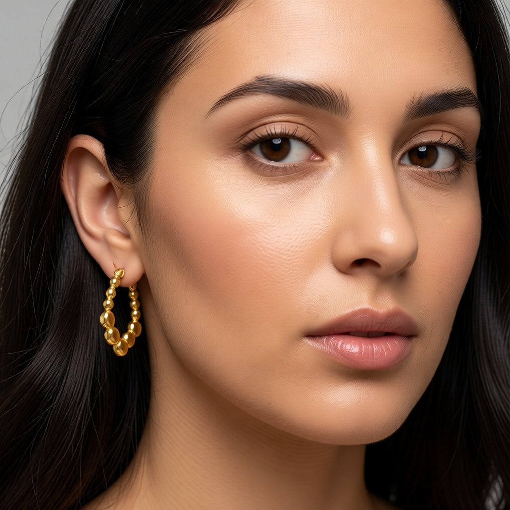 Aramat Jewels gold-tone rectangular hoop earrings with a playful beaded pattern, 21x24mm, made of stainless steel.