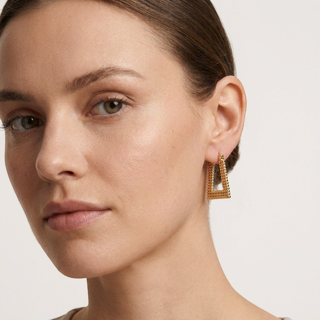 Aramat Jewels gold-tone stainless steel rectangular hoop earrings with a beaded texture, 28x20mm.