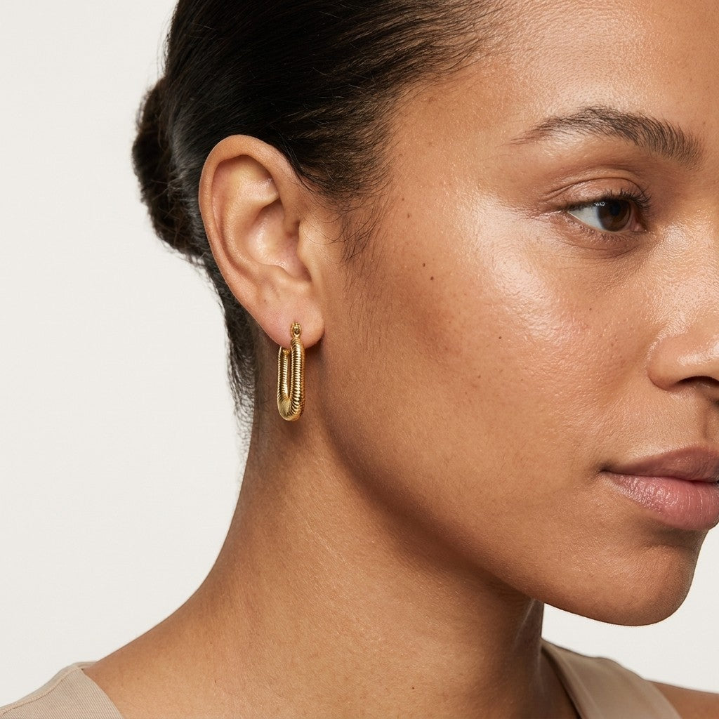 Aramat Jewels gold-tone rectangular hoop earrings with a ribbed texture, 30x16mm, made of stainless steel.