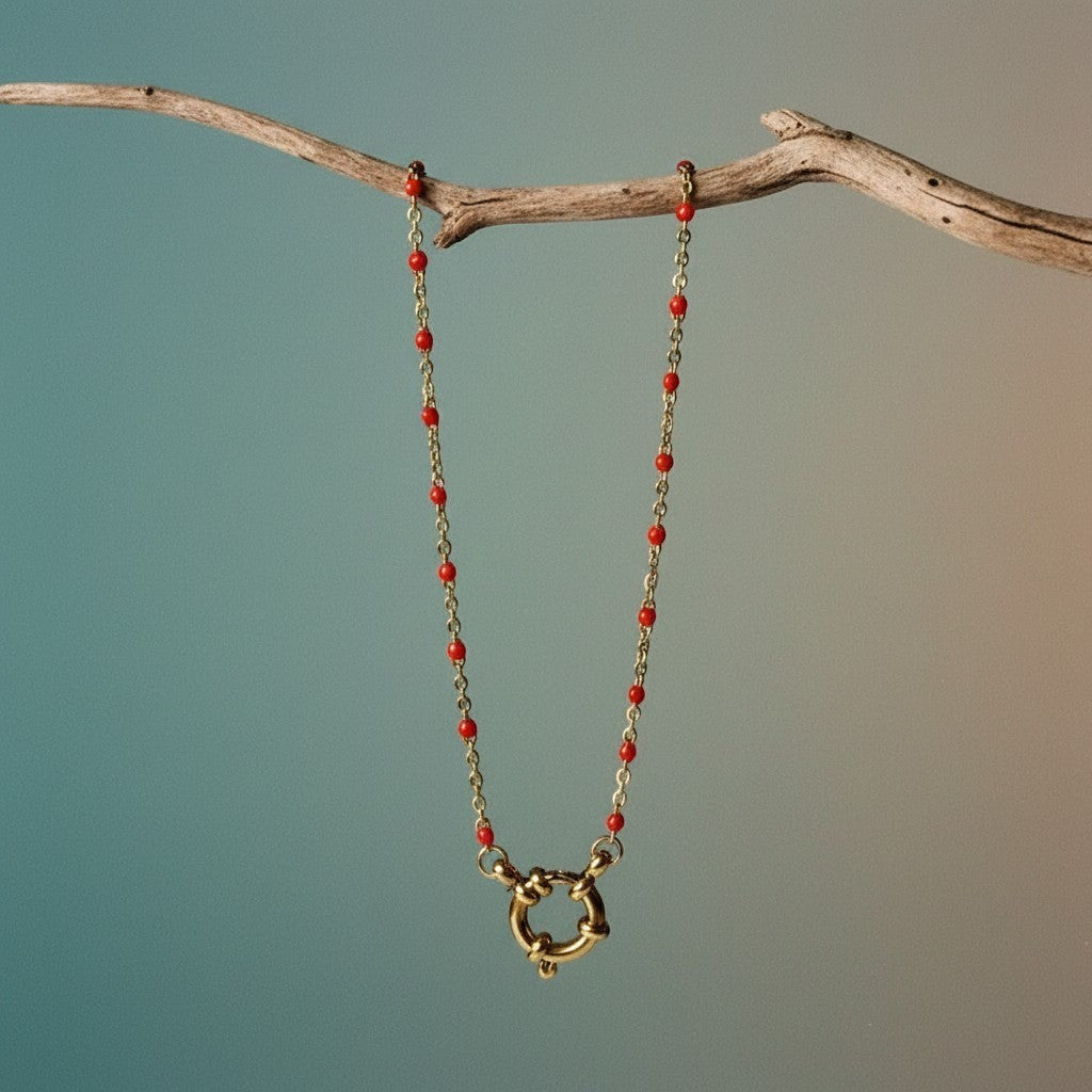Aramat Jewels gold chain necklace with small red enamel beads and a large gold clasp.