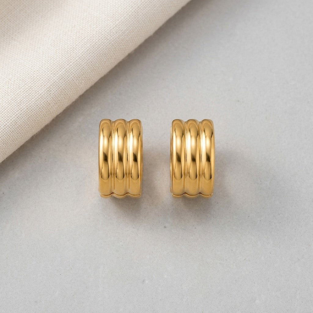 Aramat Jewels gold-tone stainless steel hoop earrings with ribbed texture, available in 13mm or 20mm.