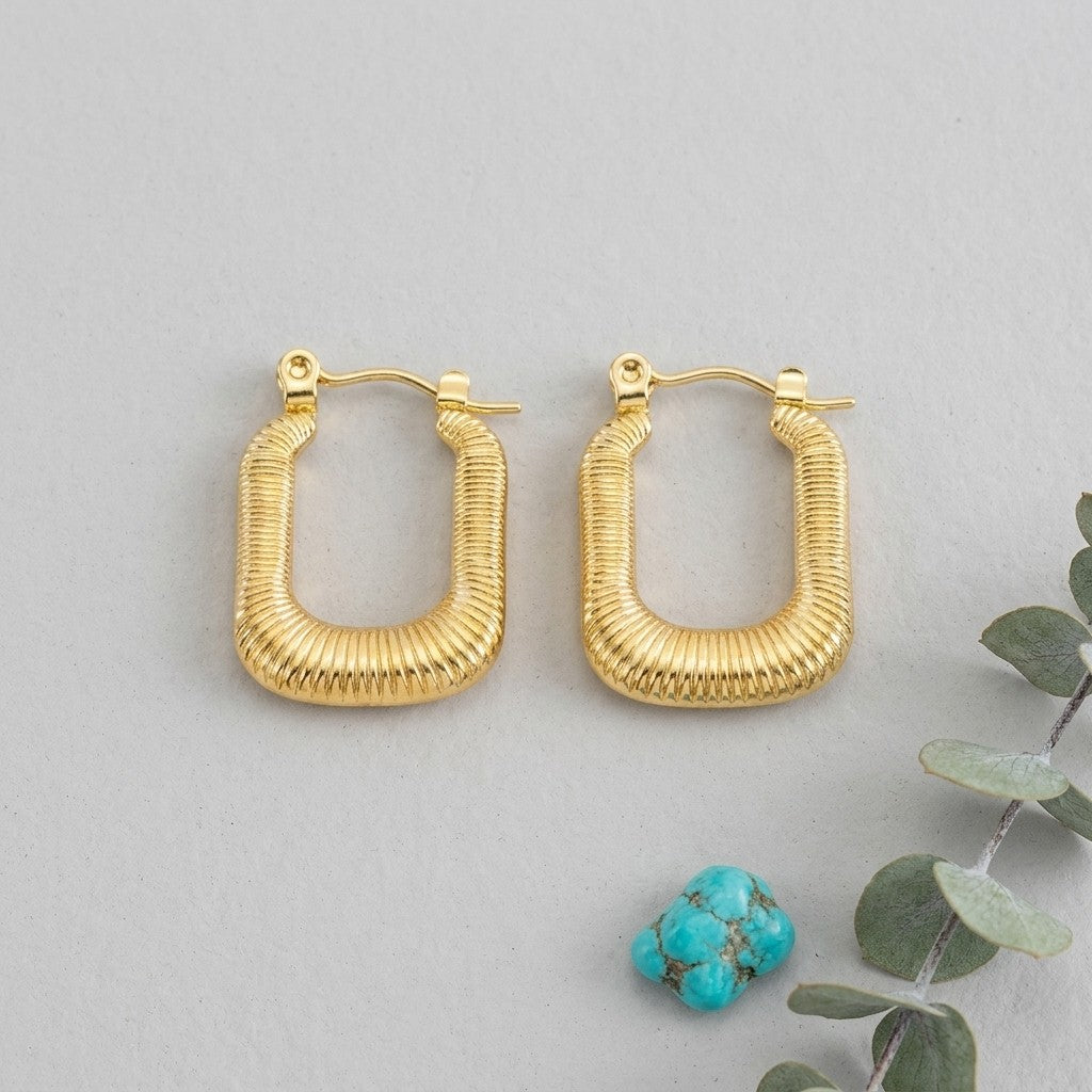 Aramat Jewels gold-tone rectangular hoop earrings with a ribbed texture, 30x16mm, made of stainless steel.