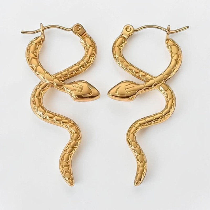 Aramat Jewels gold-colored stainless steel snake hoop earrings with textured scales, 42x17 mm.