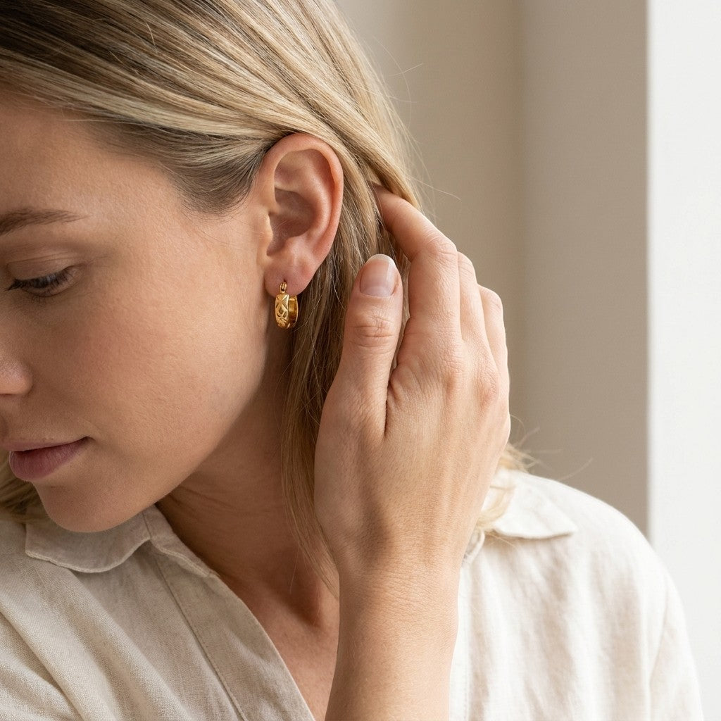 Aramat Jewels gold stainless steel hoop earrings with a subtle diamond pattern, 10mm diameter.