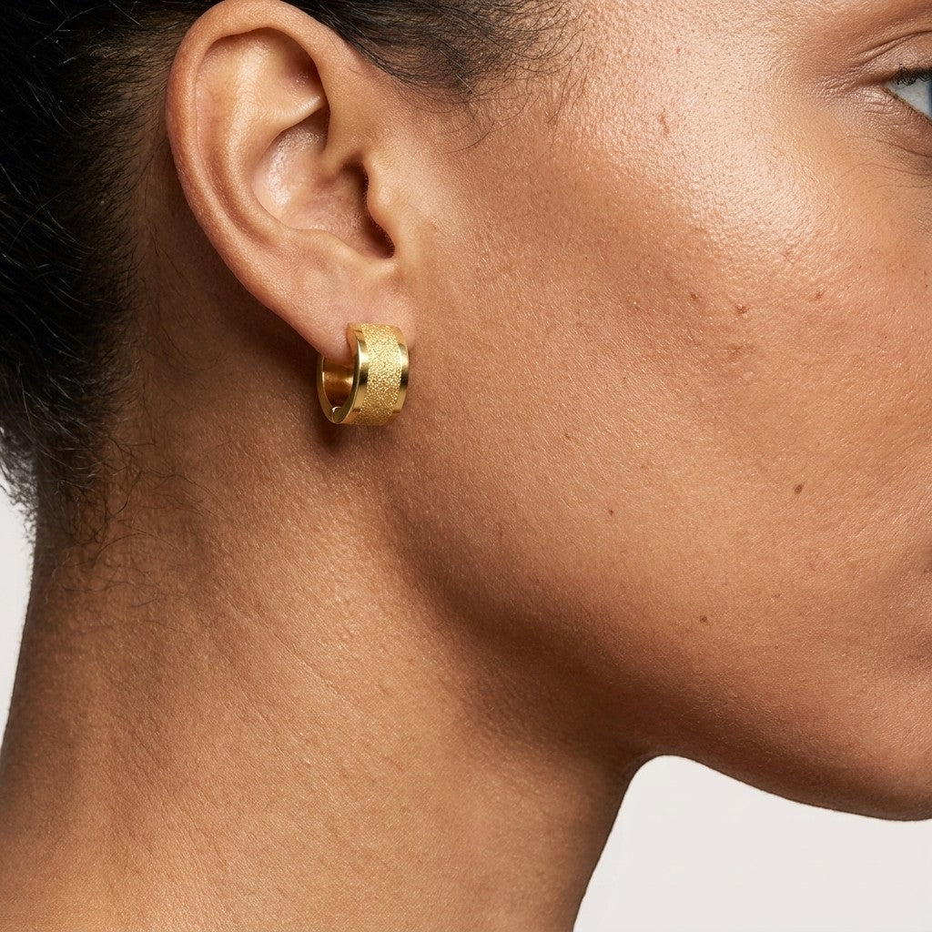 Aramat Jewels gold-tone stainless steel hoop earrings with sandblasted stripe detail, 13x7mm.