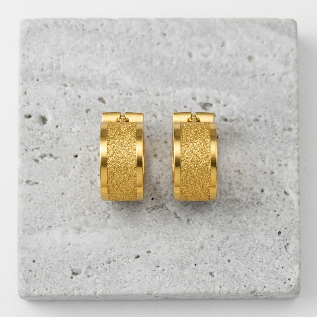 Aramat Jewels gold-tone stainless steel hoop earrings with sandblasted stripe detail, 13x7mm.