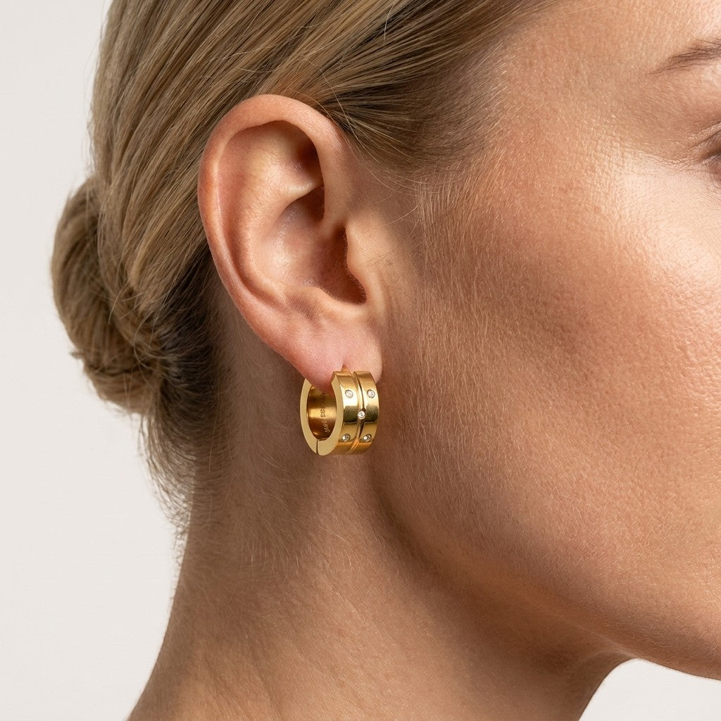 Aramat Jewels gold-tone stainless steel hoop earrings with 5 small cubic zirconia stones on each.